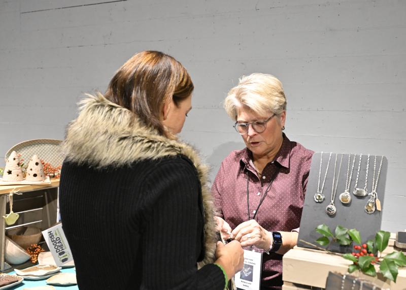 Gabrielle Koeppel receives advice from Barbara Land, a silversmith who creates individualized pieces of jewelry.